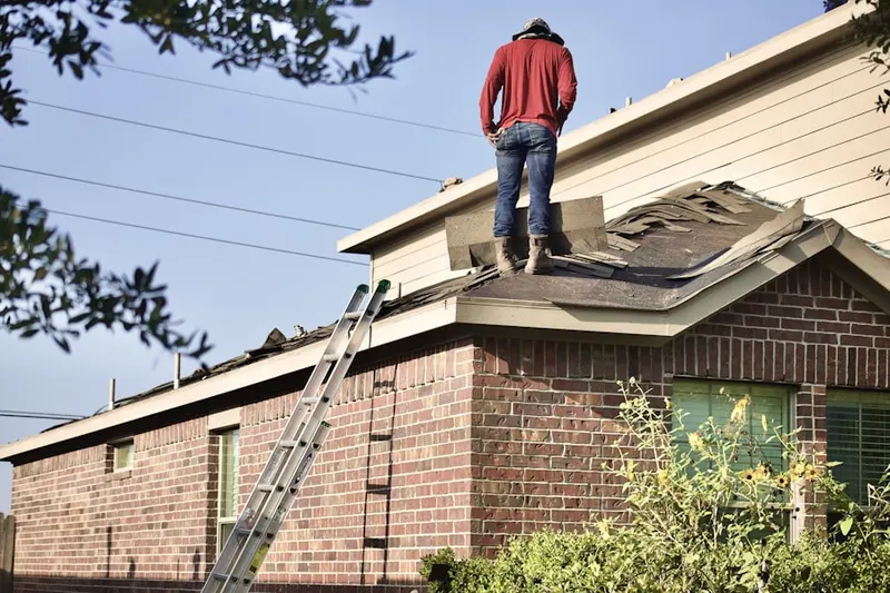 Professional roofer working on a residential roof in Northchase